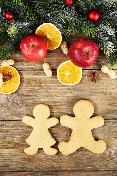 Christmas cookies and fruits on wooden table — Stock Photo, Image