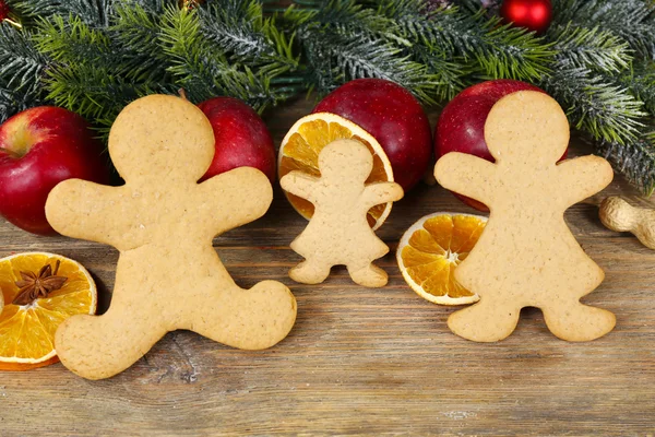 Christmas cookies and fruits on wooden table — Stock Photo, Image