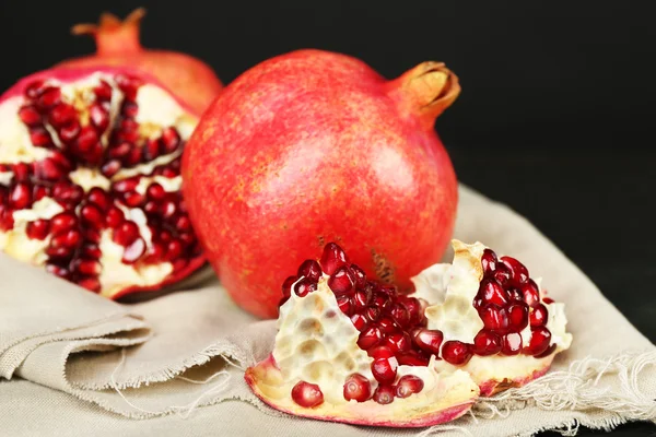 Saftige reife Granatäpfel auf dunklem Hintergrund — Stockfoto