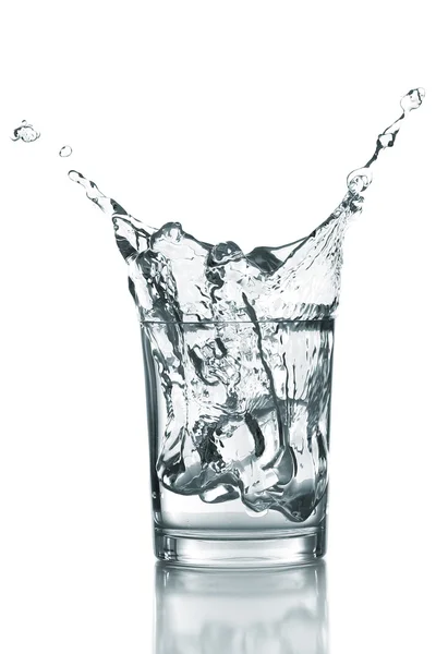 Water splash with ice in glass isolated on white — Stock Photo, Image