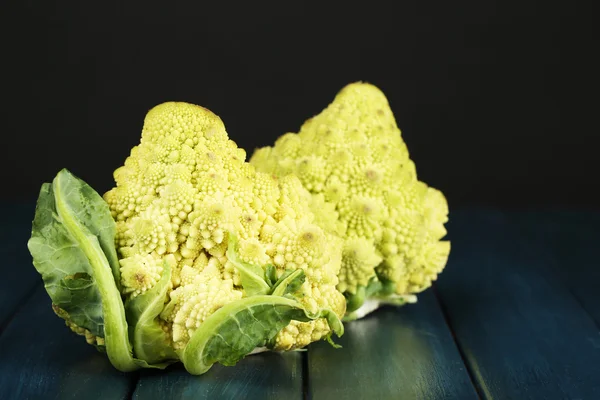 Romanesco broccoli on wooden table, on dark background — Stock Photo, Image