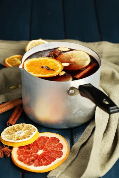 Old metal pan of tasty mulled wine on wooden table — Stock Photo, Image