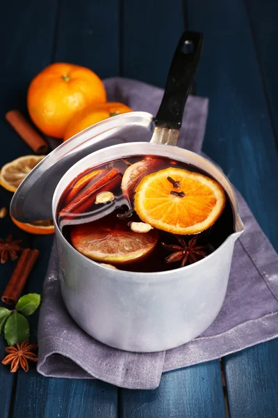 Old metal pan of tasty mulled wine on wooden table — Stock Photo, Image