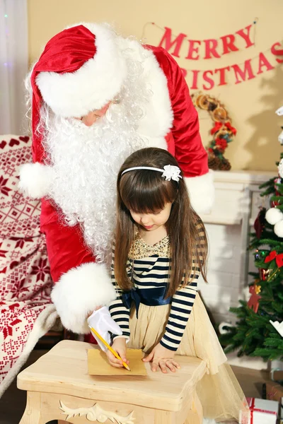 Kerstman met meisje — Stockfoto