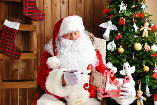 Santa Claus zitten in comfortabele schommelstoel — Stockfoto