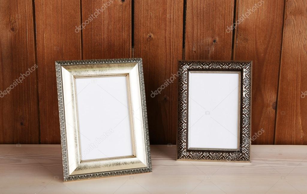 Photo frames on wooden surface