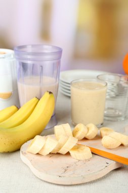 Parlak zemin üzerine ahşap masa üzerinde kesme tahtası üzerinde muz dilimlenmiş