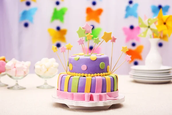 Delicioso bolo de aniversário na mesa no fundo brilhante — Fotografia de Stock