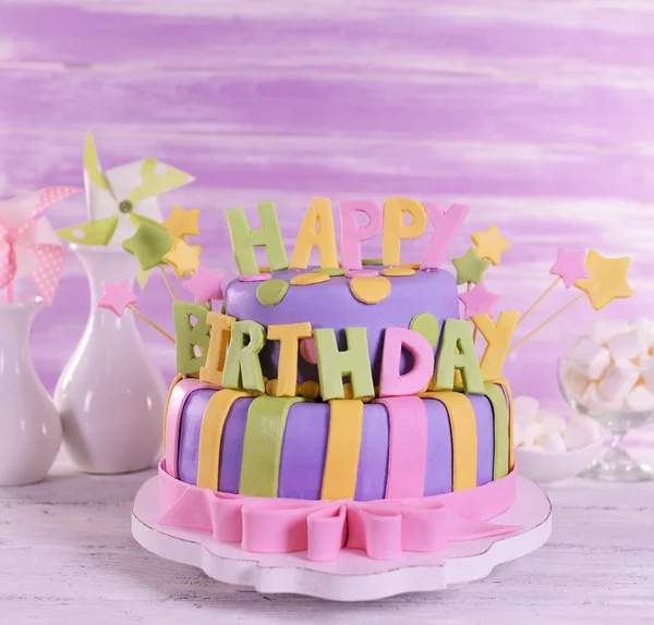 Delicious birthday cake on table on wooden background — Stock Photo, Image