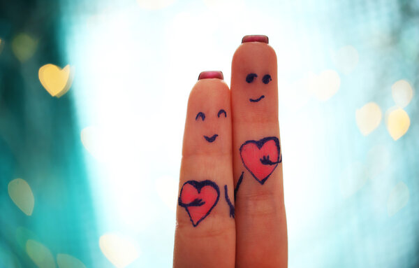 Lovers fingers on bokeh background