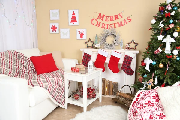 Interior de Natal bonito com sofá, lareira decorativa e abeto — Fotografia de Stock