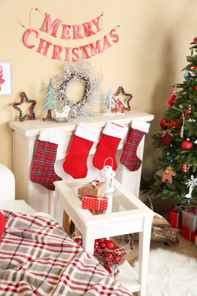 Interior de Natal bonito com sofá, lareira decorativa e abeto — Fotografia de Stock