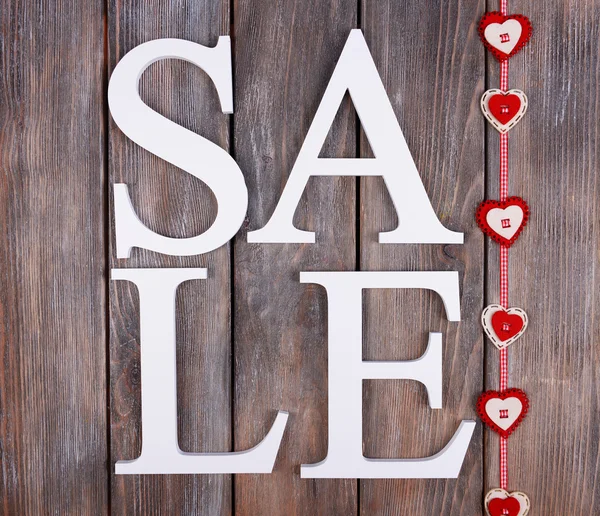Sale on wooden background — Stock Photo, Image