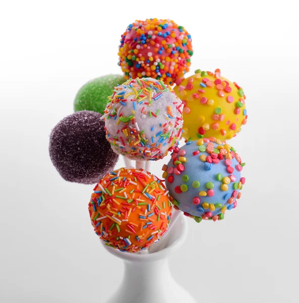 Sweet cake pops in vase isolated on white — Stock Photo, Image