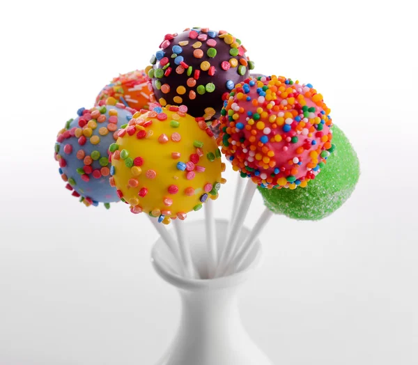 Sweet cake pops in vase isolated on white — Stock Photo, Image