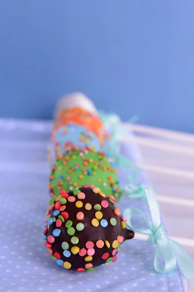 Sweet cake pops on table on blue background — Stock Photo, Image