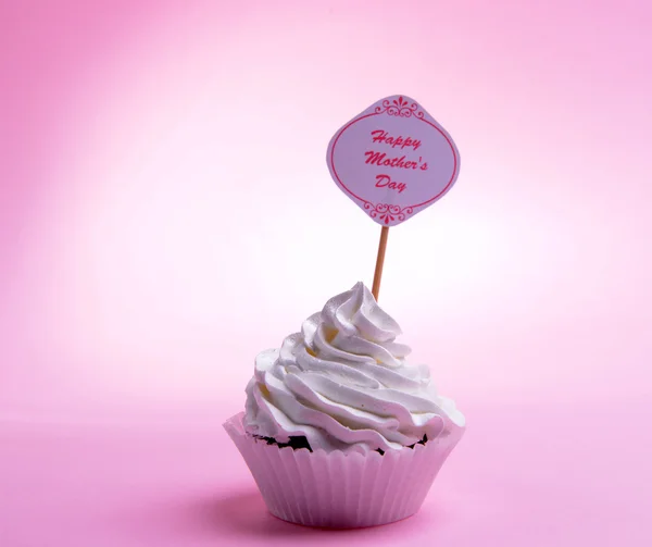 Delicious cupcake with inscription on table on pink background — Stock Photo, Image