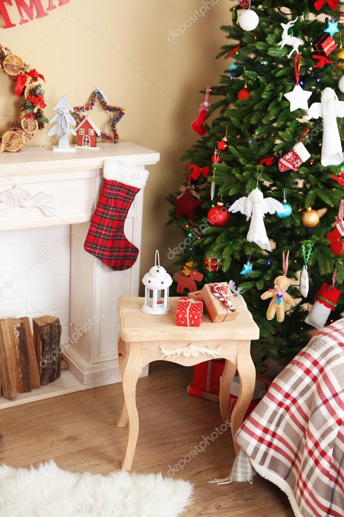 Decorated fireplace near Christmas tree. Christmas decoration concept