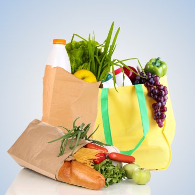 Paper bags with products on light grey background clipart