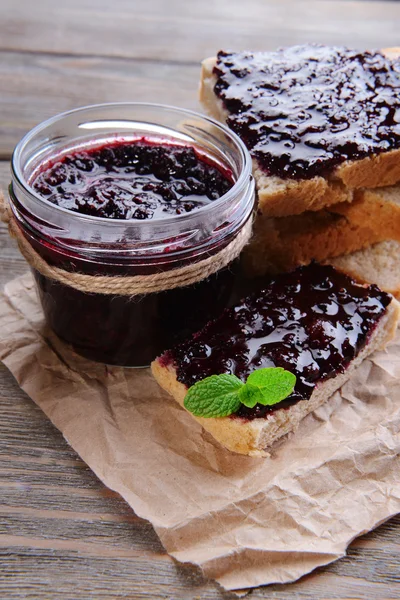 Delicious black currant jam on table close-up — Stock Photo, Image