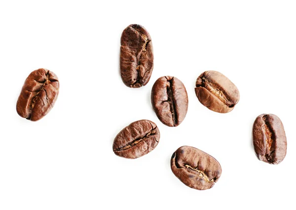 Grãos de café na mesa branca, close-up — Fotografia de Stock