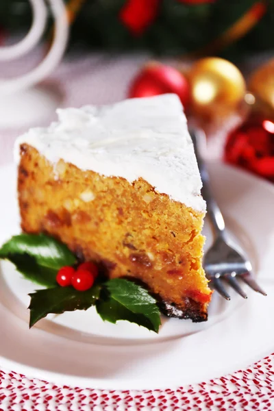 Tranche de gâteau sur la table avec décoration de Noël sur fond lumineux — Photo