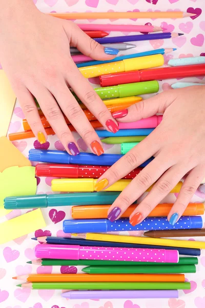 Multicolor female manicure with markers and pencils on bright background — Stock Photo, Image