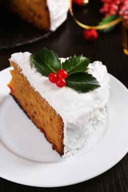 Noel dekorasyon ahşap masa arka plan üzerinde kremalı pasta dilimi kaplı