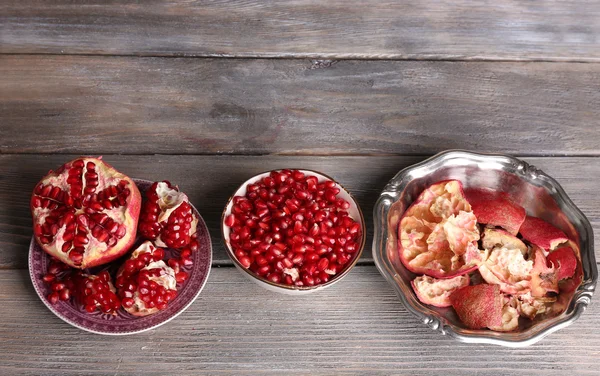 Mooie compositie met sappige granaatappel zaden, op oude houten tafel — Stockfoto