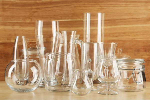 Different glassware on wooden background — Stock Photo, Image