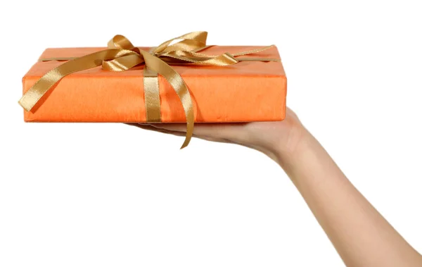 Female hand holding present box with ribbon on light background — Stock Photo, Image