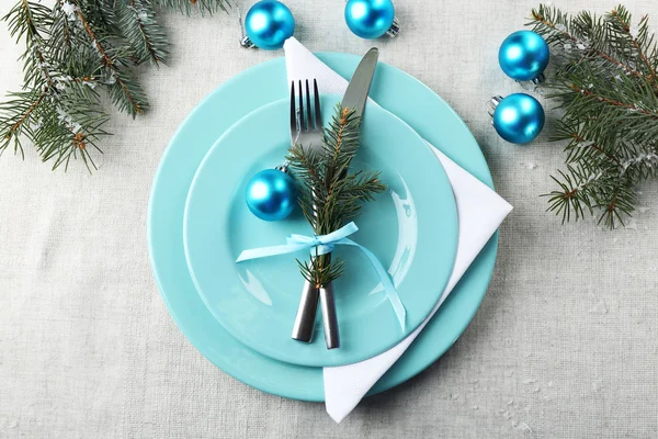 Stylish blue and white Christmas table setting on grey tablecloth background — Stock Photo, Image