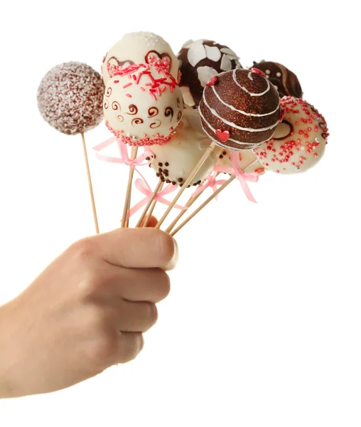 Kvinnlig hand innehav cake pops, isolerad på vit — Stockfoto