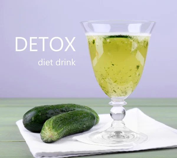 Glass of cucumber drink on napkin on wooden table, Detox diet drink concept — Stock Photo, Image