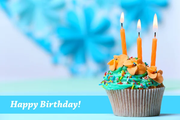 Delicious birthday cupcake on table on light background — Stock Photo, Image