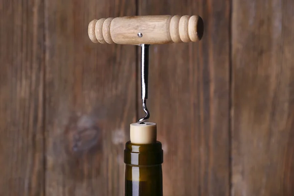 Bottle opener close-up, on wooden background — Stock Photo, Image