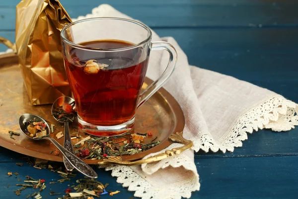 Beautiful vintage composition with herbal tea, on wooden table — Stock Photo, Image