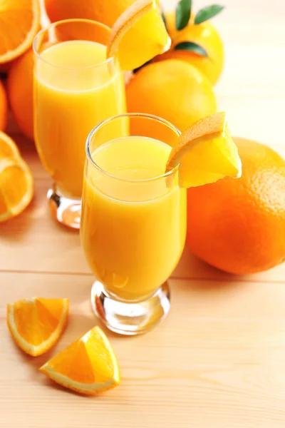 Freshly squeezed orange juice on wooden table — Stock Photo, Image