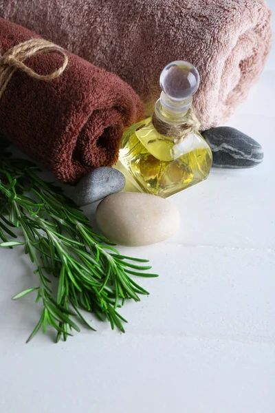 Branches of rosemary with massage oil — Stock Photo, Image