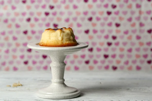 Delicioso cheesecake na mesa de madeira, no fundo de cor — Fotografia de Stock