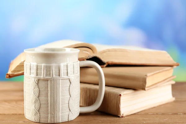 Tasse de thé et livres sur table, sur fond lumineux — Photo