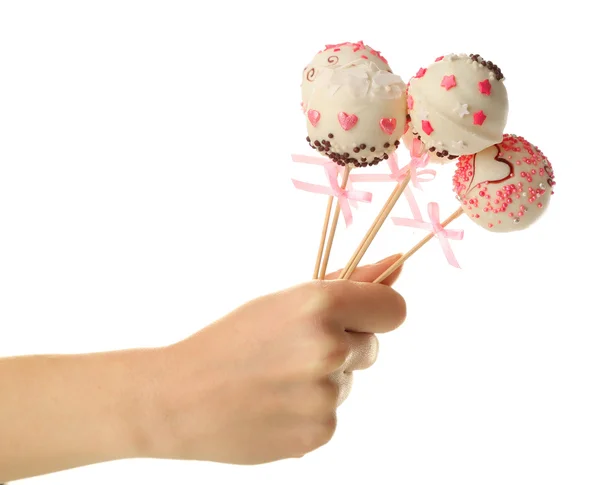 Kvinnlig hand innehav cake pops, isolerad på vit — Stockfoto