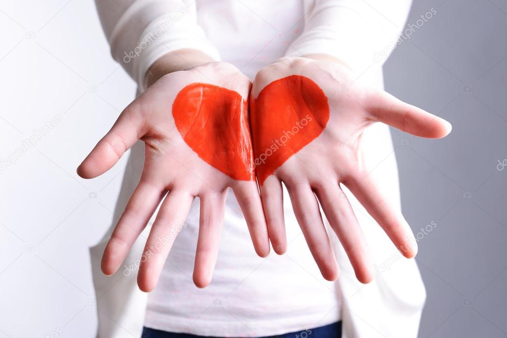 Drawing hart on female hands