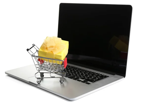 Shopping cart on laptop with gift box — Stock Photo, Image