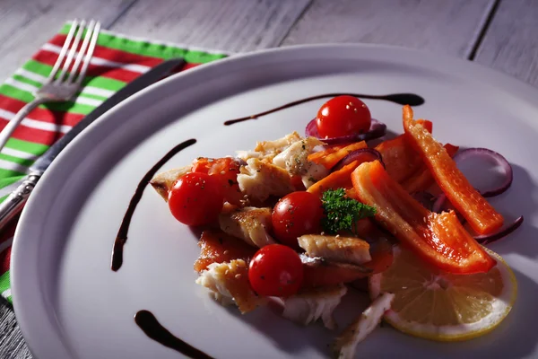 Ensalada de pescado fresco con verduras en plato sobre mesa de madera de cerca —  Fotos de Stock