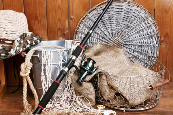 Fishing equipment on wooden wall background, indoors — Stock Photo, Image