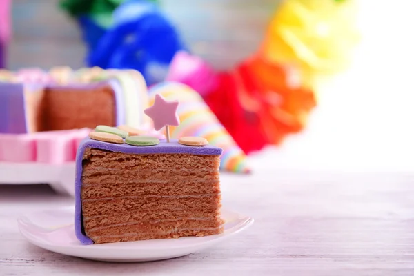 Delizioso pezzo di torta di compleanno sul tavolo su sfondo luminoso — Foto Stock