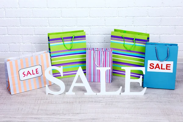 Sale with bags on floor on bright background — Stock Photo, Image