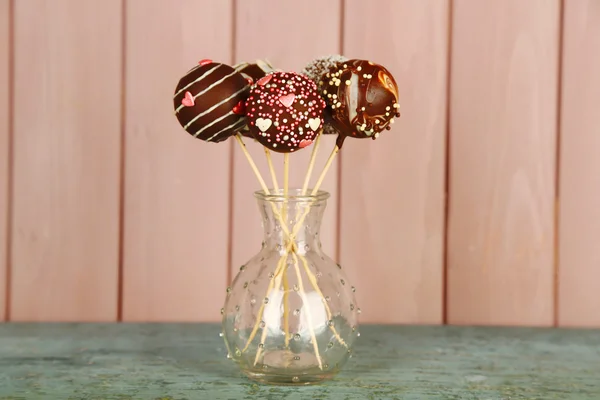 Tasty cake pops on wooden background — Stock Photo, Image