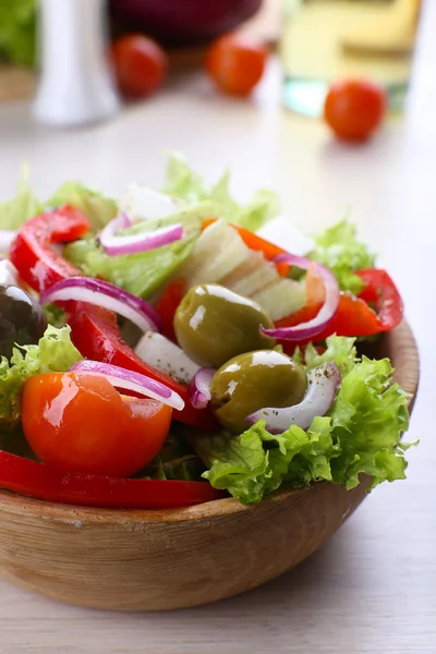 Greek salad in bow on wooden table background — Stock Photo, Image